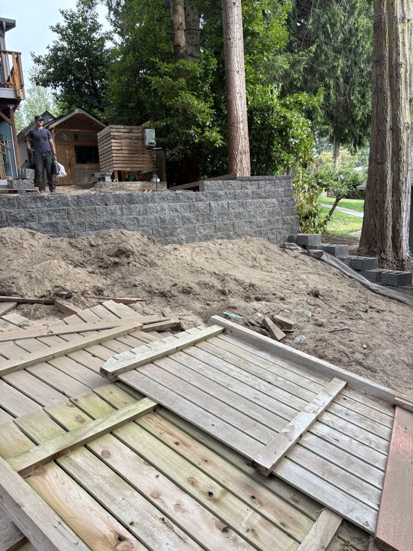 New block retaining wall, with the old deck torn out in front of it